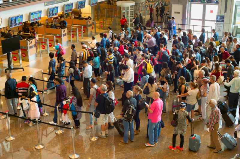people waiting in line at the airport